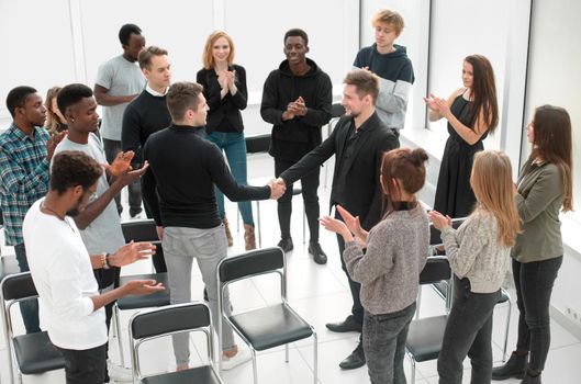 group of happy young people applauding their leaders. the concept of success