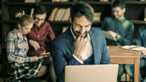 sales Manager with a laptop and a business team discussing the current problems of the company