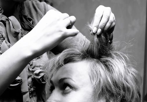 beautiful woman sitting in a hair salon.black-and-white photo in retro style