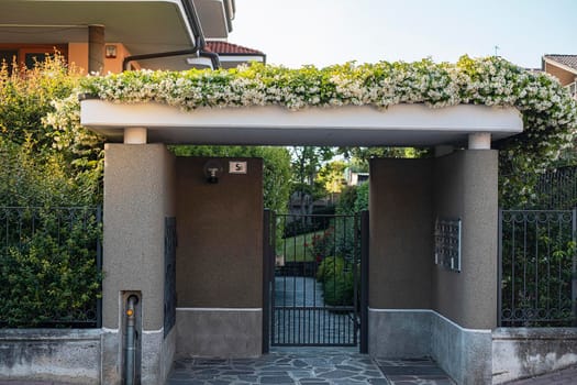 The front door to the house envelops jasmine flowers.