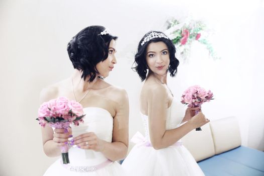bride with wedding bouquet looks in the mirror .the holidays and events