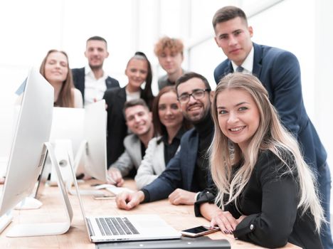 close up.a group of happy employees in the workplace. the concept of teamwork