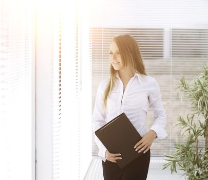 successful business woman with clipbord standing in a modern office.photo with place for text