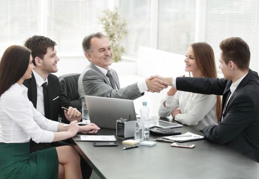 businessman and investor shake hands at the negotiating table in the office