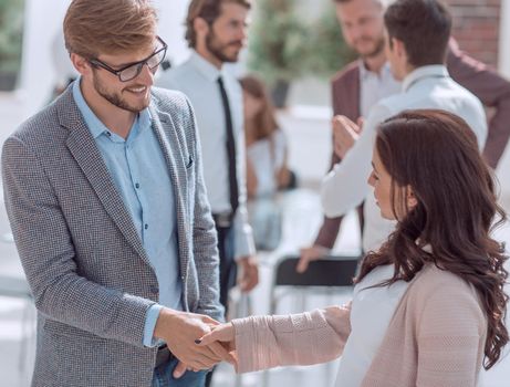 smiling Manager greeting the customer in a modern office. concept of cooperation