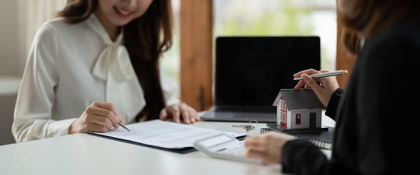 Real estate agent or bank officer describes the loan interest to the customer with home purchase contracts or on office loans and interest rates.