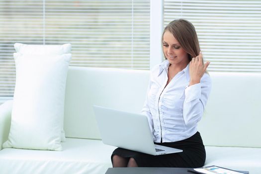 young business woman with laptop on the background of the office.photo with place for text