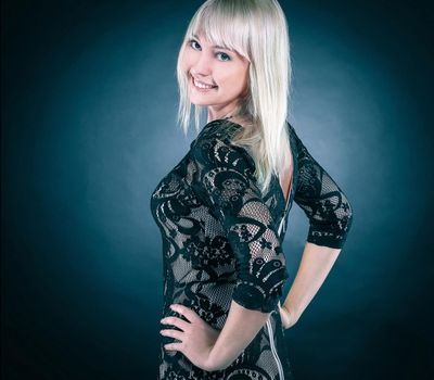 portrait of beautiful young woman in evening black dress. isolated on black.photo with copy space.
