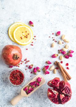 Arab ingredients, middle eastern food. Space for text. Arabic cuisine ingredients, white concrete background. Rose buds, spices, pomegranate, lemon. Halal food making. Top view. Arab food concept