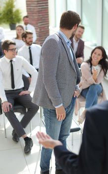 young man asks a question to the speaker during a business seminar.