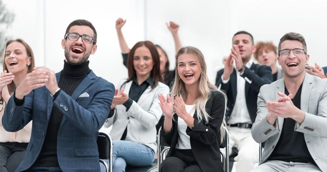 group of happy employees applauds in the conference room. the concept of success