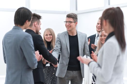 smiling business partners shaking hands with each other . concept of cooperation