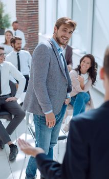 young man asks a question to the speaker during a business seminar.