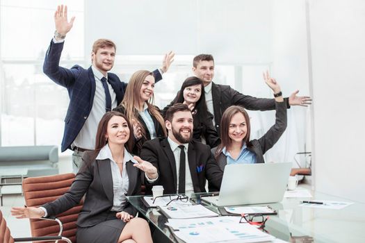 successful business team with their hands up for voting in the workplace