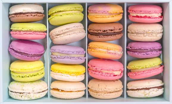 Set of different french cookies macaroons macaroons in a paper box. Top view. Coffee, chocolate, vanilla, lemon, rapsberry, strawberry, pistachio, violet, rose, orange tastes macaroons