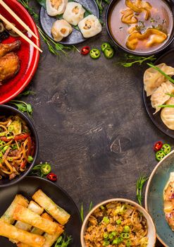 Chinese food dark background. Chinese noodles, fried rice, dumplings, peking duck, dim sum, spring rolls. Famous Chinese cuisine dishes set. Space for text. Top view. Chinese restaurant concept