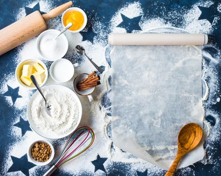 Baking background. Flour, sugar, eggs, butter, milk, cinnamon sticks, whisk, rolling pin, baking paper. Space for text. Ingredients for baking. Kitchen utensils. Top view. Making baked goods. Concept