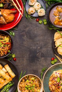 Chinese food dark background. Chinese noodles, fried rice, dumplings, peking duck, dim sum, spring rolls. Famous Chinese cuisine dishes set. Space for text. Top view. Chinese restaurant concept