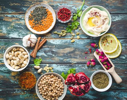 Arab ingredients for middle eastern food. Arabic cuisine ingredients. Background. Hummus, chickpea, lentils, rose buds, spices, pomegranate, pistachios. Halal food making. Space for text. Top view