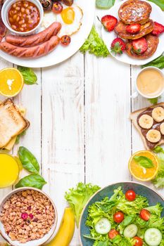 Assortment of breakfast choices. English breakfast, sausages, fried eggs, bacon, salad, granola, cheese sandwich, pancakes, chocolate cream and banana toast, coffee, fresh orange juice. Space for text