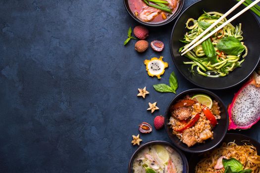 Thai food background. Dishes of thai cuisine. Tom yum, tom kha gai, pad thai noodles, thai fried rice with pork and vegetables khao phat mu, green papaya salad som tam, thai fruits. Space for text