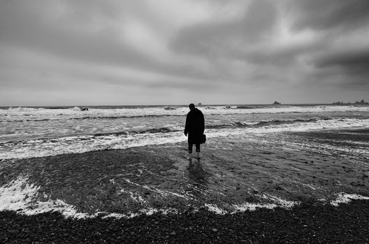 Lonely figure on a stormy beach in Washington