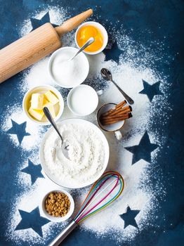 Baking concept. Flour, white, brown sugar, eggs, butter, milk, cinnamon sticks, whisk, rolling pin. Ingredients for baking. Kitchen utensils. Top view. Making baked goods. Set of assorted ingredients