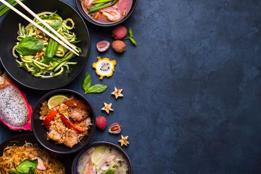 Thai food background. Dishes of thai cuisine. Tom yum, tom kha gai, pad thai noodles, thai fried rice with pork and vegetables khao phat mu, green papaya salad som tam, thai fruits. Space for text