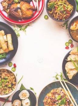 Chinese food white background. Chinese noodles, fried rice, dumplings, peking duck, dim sum, spring rolls. Famous Chinese cuisine dishes set. Space for text. Top view. Toned image