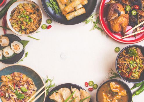 Chinese food white background. Chinese noodles, fried rice, dumplings, peking duck, dim sum, spring rolls. Famous Chinese cuisine dishes set. Space for text. Top view. Toned image