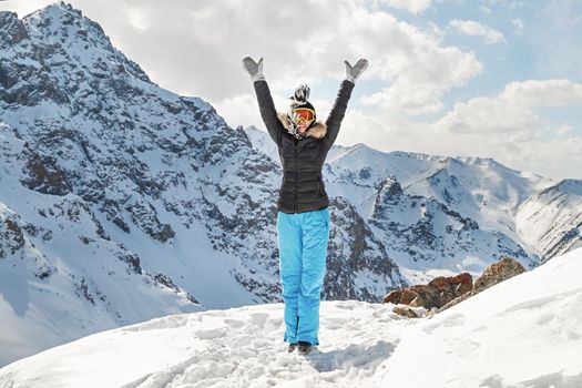 Cute young woman. Happy hiker winning reaching life goal, success, freedom and happiness, achievement in mountains. Tian Shan mountain travel. Copy space
