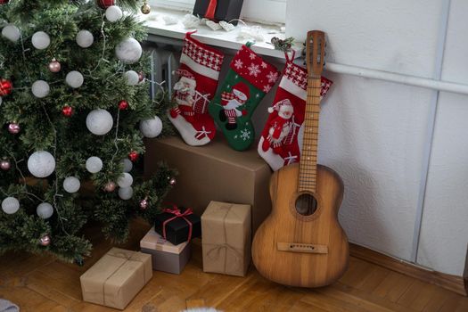 Guitar with decorated Christmas Tree in the background.