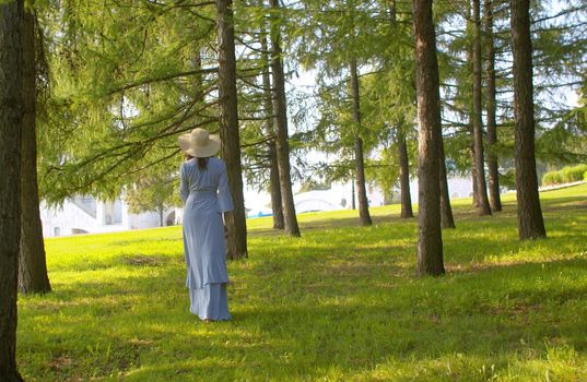 Beautiful dreamy woman walking in the park