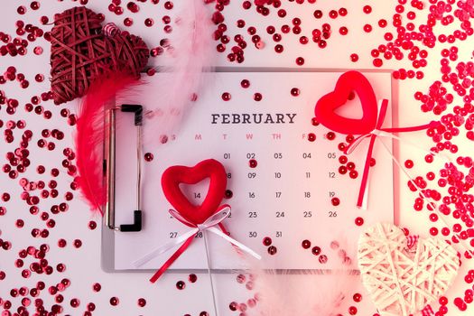 Calendar with 14th of February date. Planning Valentines day holiday. Love romantic dating. Preparing with hearts. Candles romance