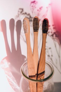 Bamboo toothbrush. Biodegradable, organic on a white background with deep trendy shadows. Eco friendly life style concept, zero waste. Eco bathroom without plastic. Copy space