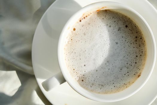 Dirty white cup of tea with milk foam. Morning coffee. Latte cappuccino. Breakfast. cafe