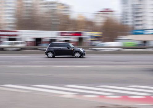 Ukraine, Kyiv - 18 March 2021: Black MINI Cabrio car moving on the street. Editorial