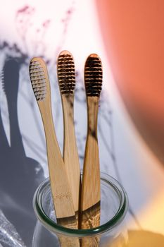 Bamboo toothbrush. Biodegradable, organic on a white background with deep trendy shadows. Eco friendly life style concept, zero waste. Eco bathroom without plastic. Copy space