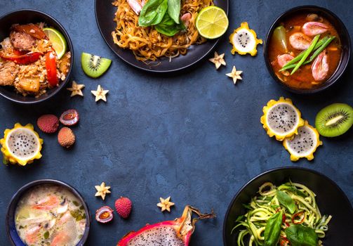 Thai food background. Dishes of thai cuisine. Tom yum, tom kha gai, pad thai noodles, thai fried rice with pork and vegetables khao phat mu, green papaya salad som tam, thai fruits. Space for text