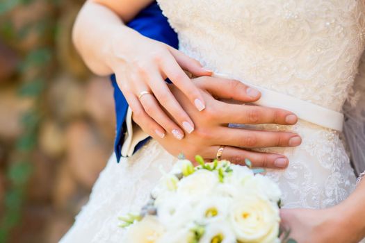 bride and groom holding hands with a bouquet
