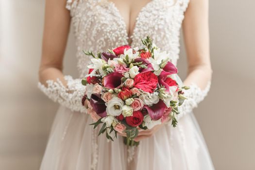 Beautiful wedding bouquet in hands of the bride