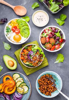 Mixed healthy vegetarian salads with vegetables, sweet potato, falafel, bulgur, avocado, eggs. Assorted buddha bowl salads. Vegetarian food. Healthy lunch/dinner. Salad in bowl. Ingredients for making