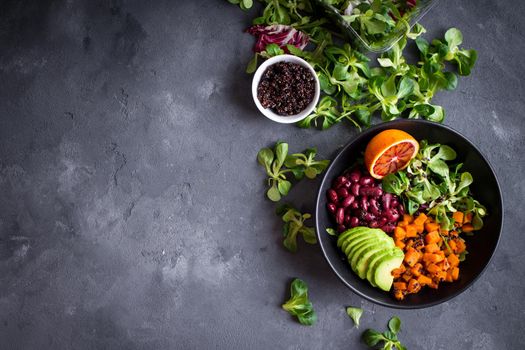 Fresh quinoa organic vegetables salad in bowl on concrete rustic background. Quinoa superfood concept. Clean healthy detox eating. Vegan/vegetarian food. Making healthy salad. Space for text. Top view