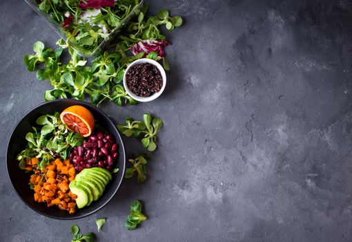 Fresh quinoa organic vegetables salad in bowl on concrete rustic background. Quinoa superfood concept. Clean healthy detox eating. Vegan/vegetarian food. Making healthy salad. Space for text. Top view