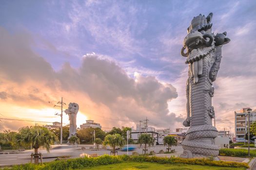 okinawa, japan - september 15 2021: Sunrise on the  giant stone dragon head of the pillars that greet cruise ship visitors close to the Naha Port Cruise Terminal dock, symbol of sister cities Naha and Fuzhou in China.