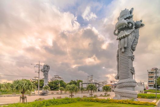 okinawa, japan - september 15 2021: Sunrise on the  giant stone dragon head of the pillars that greet cruise ship visitors close to the Naha Port Cruise Terminal dock, symbol of sister cities Naha and Fuzhou in China.