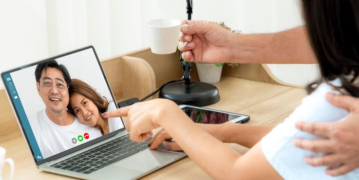 Family happy video call while stay safe at home during covid-19 coronavirus outbreak. Concept of people connection call technology with online video camera.