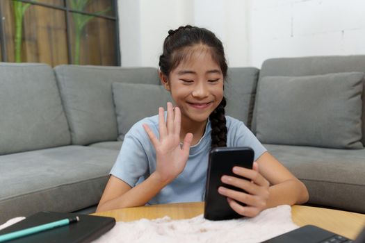 Little asian girl using videocall on her phone