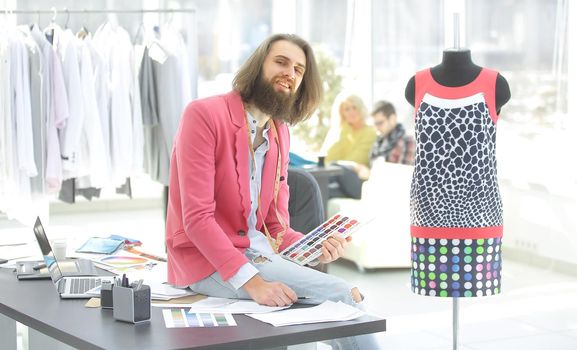 portrait of a fashionable tailor in a modern Studio.