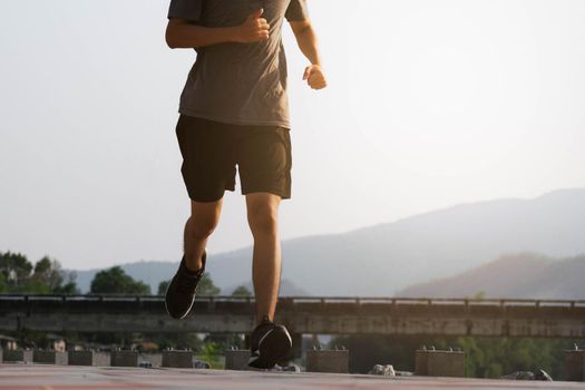 Young man runner feet running on the road be running for exercise. healthy exercise concept.